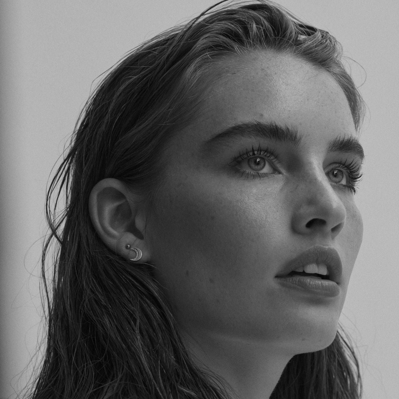 Half Moon Stud Silver Earrings by Tipperary Crystal  Inspired by the hypnotic energy of the glowing moon, this collection is contemporary and minimalist yet luxuriously adorned with the clearest sparkling stones.