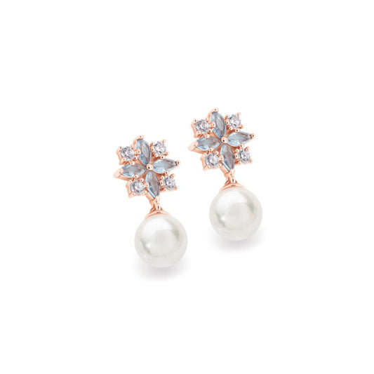 These elegant pearl and crystal post earrings are a captivating look. Fashioned in elegant Rose gold each shimmering earring highlights a luminous pearl topped by an art deco inspired arrangement of 4 dolphin grey marquise shape and round clear CZs. These demure earrings secure comfortably with push backs.