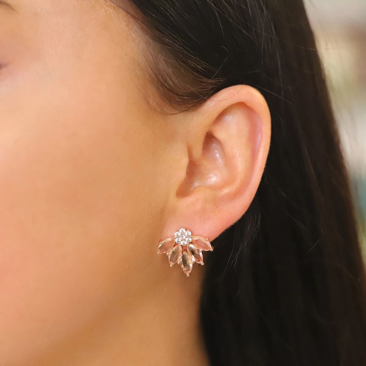 These exquisite earrings will enhance any outfit. Crafted in glowing Rose gold these magnificent stud earrings consist of delicate peach marquise cut CZ arranged around a dark sultry pave arrangement. They secure comfortably with push backs.