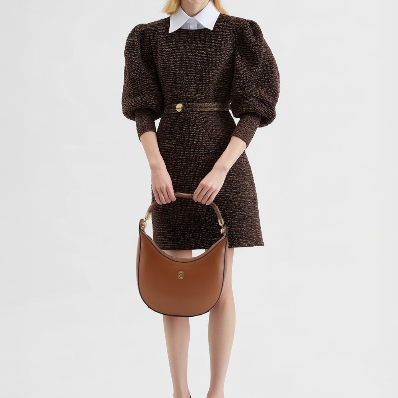 The Tipperary Moon Handbag in tan offers a refined blend of style and practicality for summer 2025. Crafted with attention to detail, its sleek silhouette and warm tan hue complement a variety of outfits, making it an essential accessory for the season.