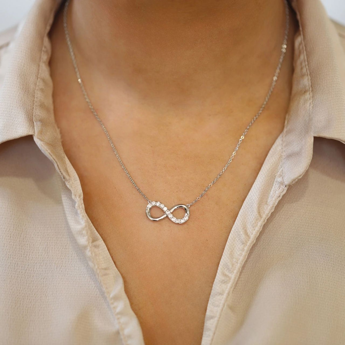 Sleek, sophisticated and eternally elegant, gift that special someone with this shimmering necklace and celebrate your eternal love. This design is on trend in cool silver and features a ﬂowing inﬁnity symbol adorned with a glittering splash of bright clear crystals.