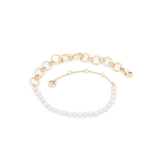 This gold bracelet by Tipperary features delicate pearls and intricate rings, making it the perfect accessory for any occasion. The elegant design adds a touch of sophistication to any outfit, while the high-quality materials ensure long-lasting wear. Elevate your jewellery collection with the Tipperary Pearl &amp; Rings Bracelet Gold.