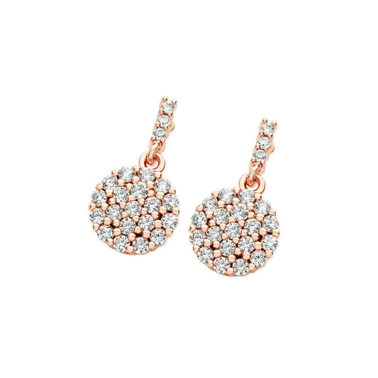 Rose Gold Drop CZ Earrings by Tipperary  A shimmering choice, these cute pavé crystal set front and back earrings are sure to be a fovourite worn again and again. Fashioned in on-trend rose gold, each post earring showcases mesmerising round clear crystall composites. The discs suspend from a linear drop lined with a trio of beautiful round crystals, cut to enhance their brilliance and shine.