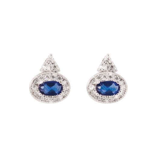Silver Earrings Oval Sapphire by Tipperary Crystal  These radiant vintage-inspired earrings will be treasured for years to come. Crafted in silver, this feminine look features a beautiful oval shaped rich blue crystal. Shimmering round clear crystals form a halo around the dazzling center stone. A trio of stacked bright round crystal stones create a sparklingly delicate stud. Polished to a brilliant lustre, they secure comfortably with push backs. Matching pendant available.