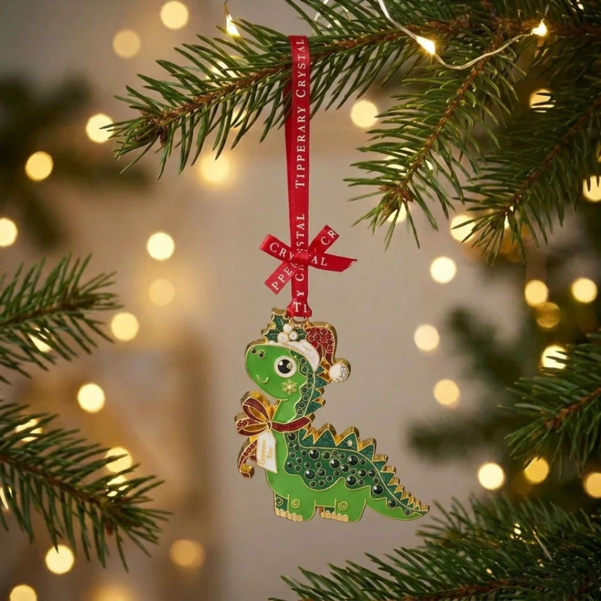 Add some prehistoric fun to your Christmas tree with this adorable green dinosaur, complete with a festive Santa hat and sparkling details.