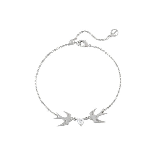 The Swallow Bracelet 2 Swallows and Heart CZ – Silver features two silver swallows gracefully flying toward a sparkling heart-shaped CZ crystal. This bracelet symbolizes love, freedom, and the beauty of connection. Its elegant design and shimmering heart add a touch of romance and sophistication, making it a perfect accessory for any occasion.