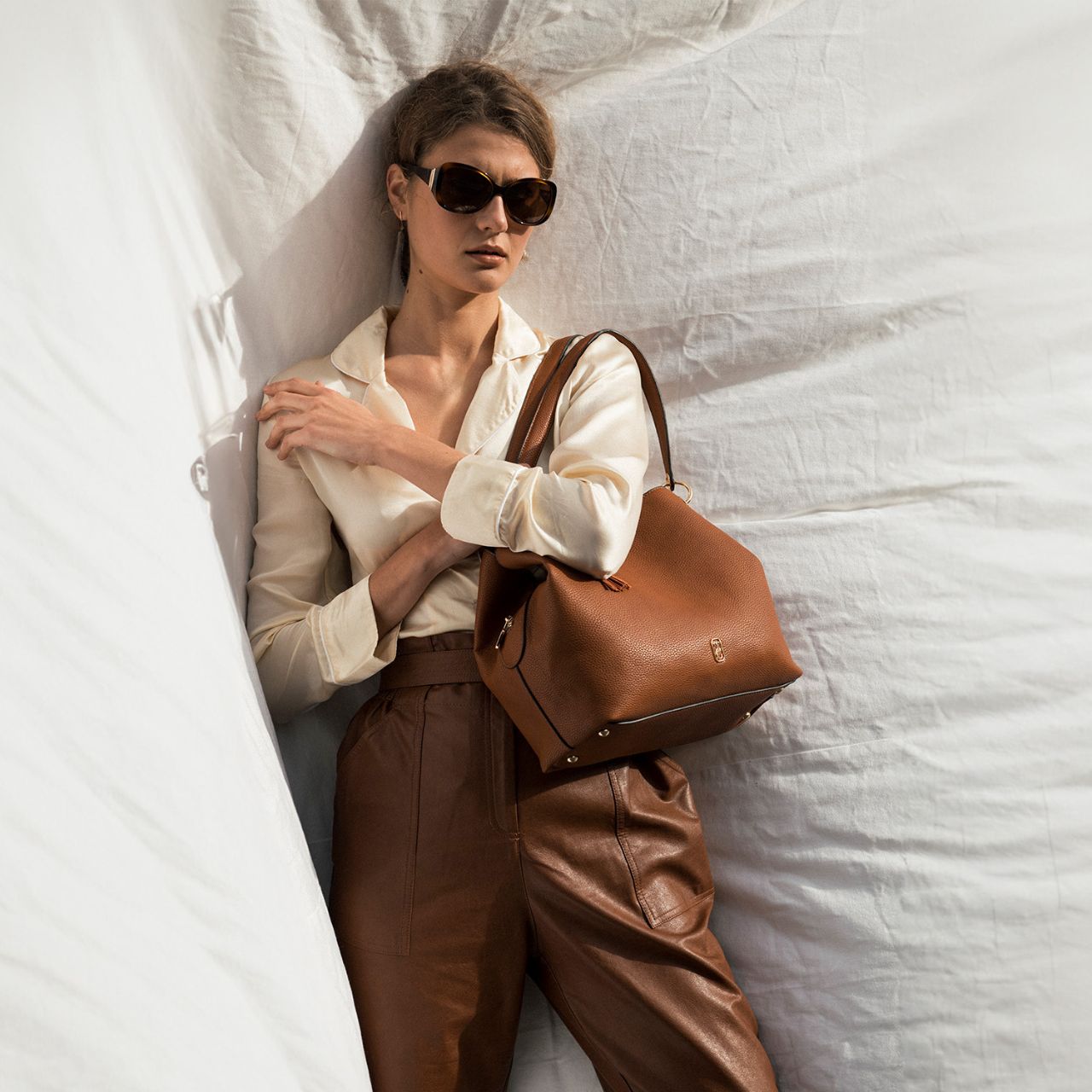 Our effortless Sicily Shoulder Bag is so comfortable you’ll want to carry it everywhere. This bag is crafted using soft pebbled leather look PU, the contrast of this with the metal hardware makes for a very attractive and practical bag.