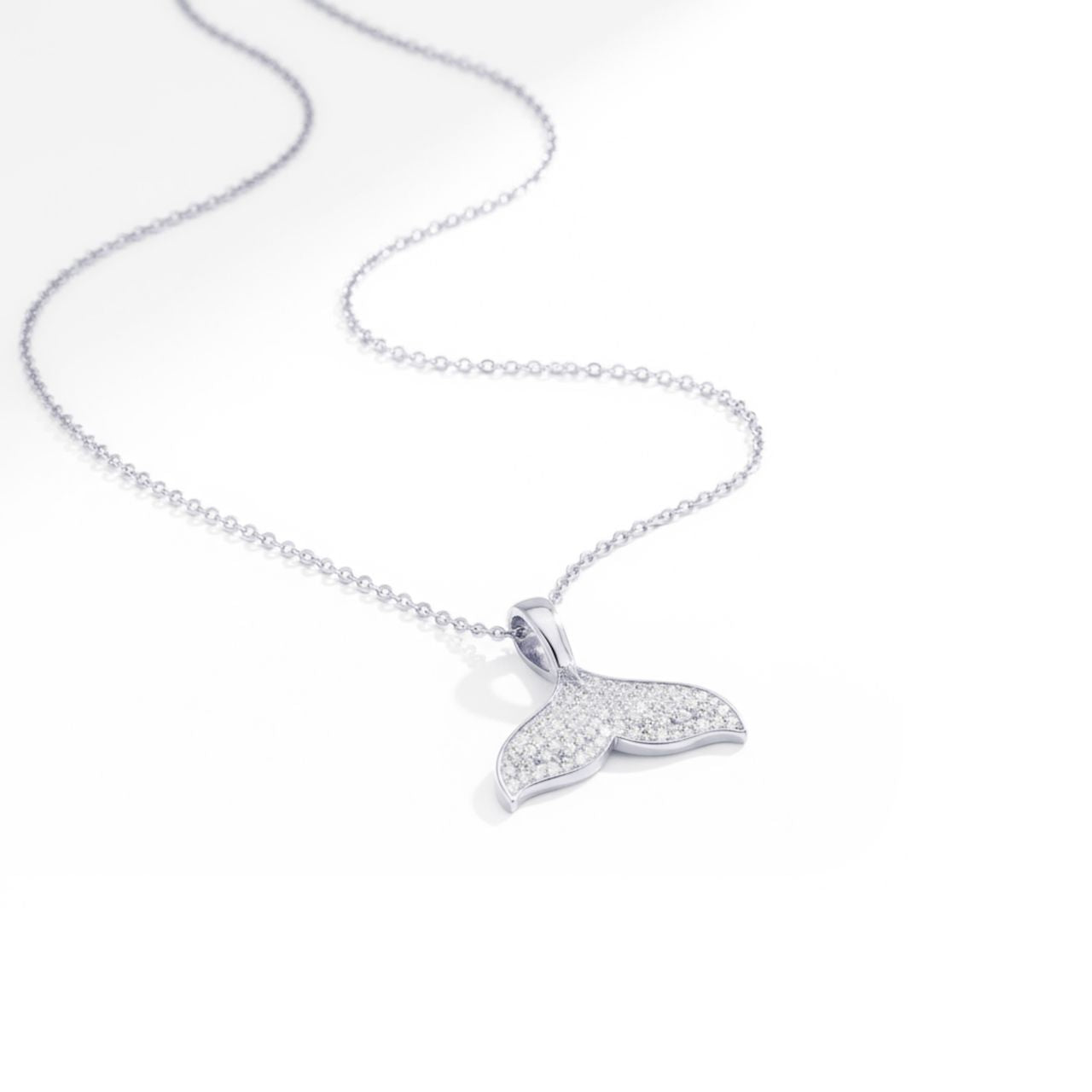 Dive into oceanic elegance with this stunning Pave Whale Tail Silver Plated Pendant from Tipperary. Crafted with meticulous detail, the whale tail design features shimmering pave-set stones that catch the light beautifully, creating a mesmerising sparkle.