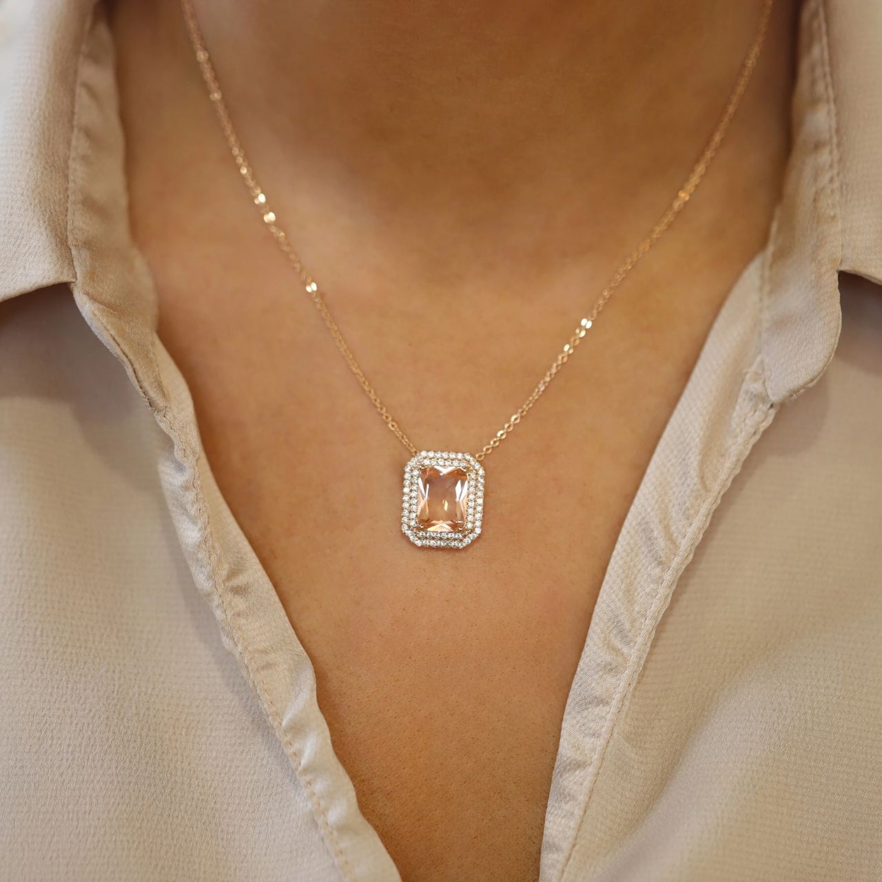 An elegant eye-catching glamourous pendant. Fashioned in a beautiful soft peach colour, the classic contemporary rectangular stone is set within a beautiful CZ mounting. Can be worn day or night to dress up any outfit.