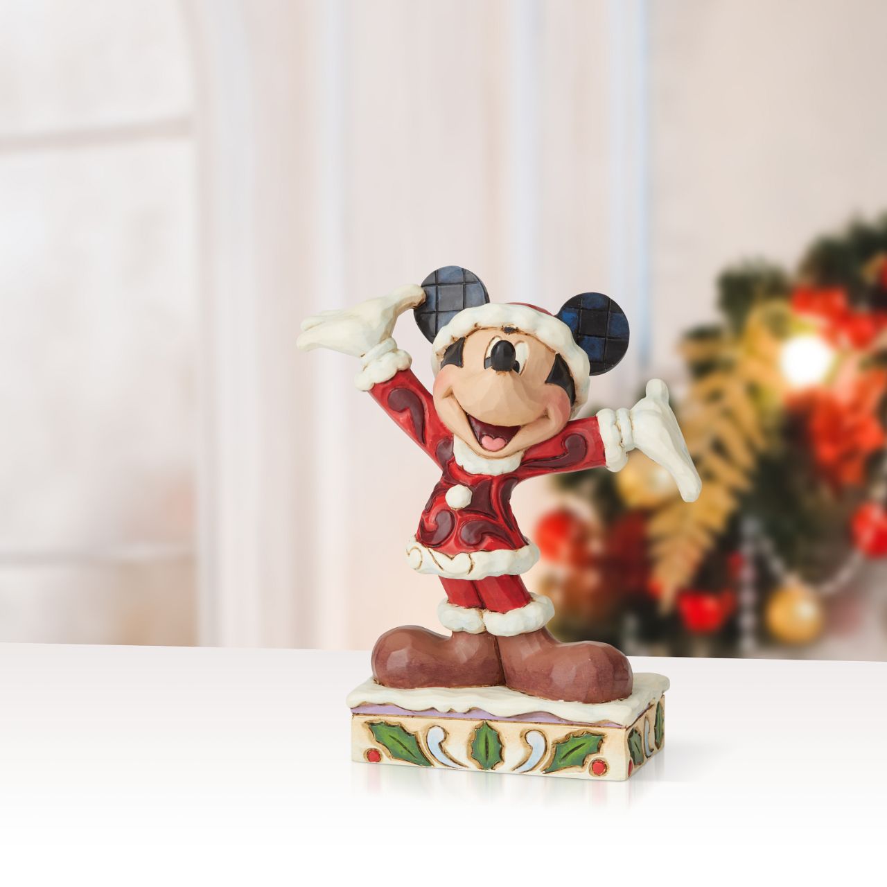 Jim Shore Tis a Splendid Season - Mickey Mouse Figurine  Dressed in his Santa suit, Mickey is excited for the arrival of the fun holiday season. This holiday Mickey is hand-crafted in cast stone and hand painted with Jim Shore's signature rosemaling design.