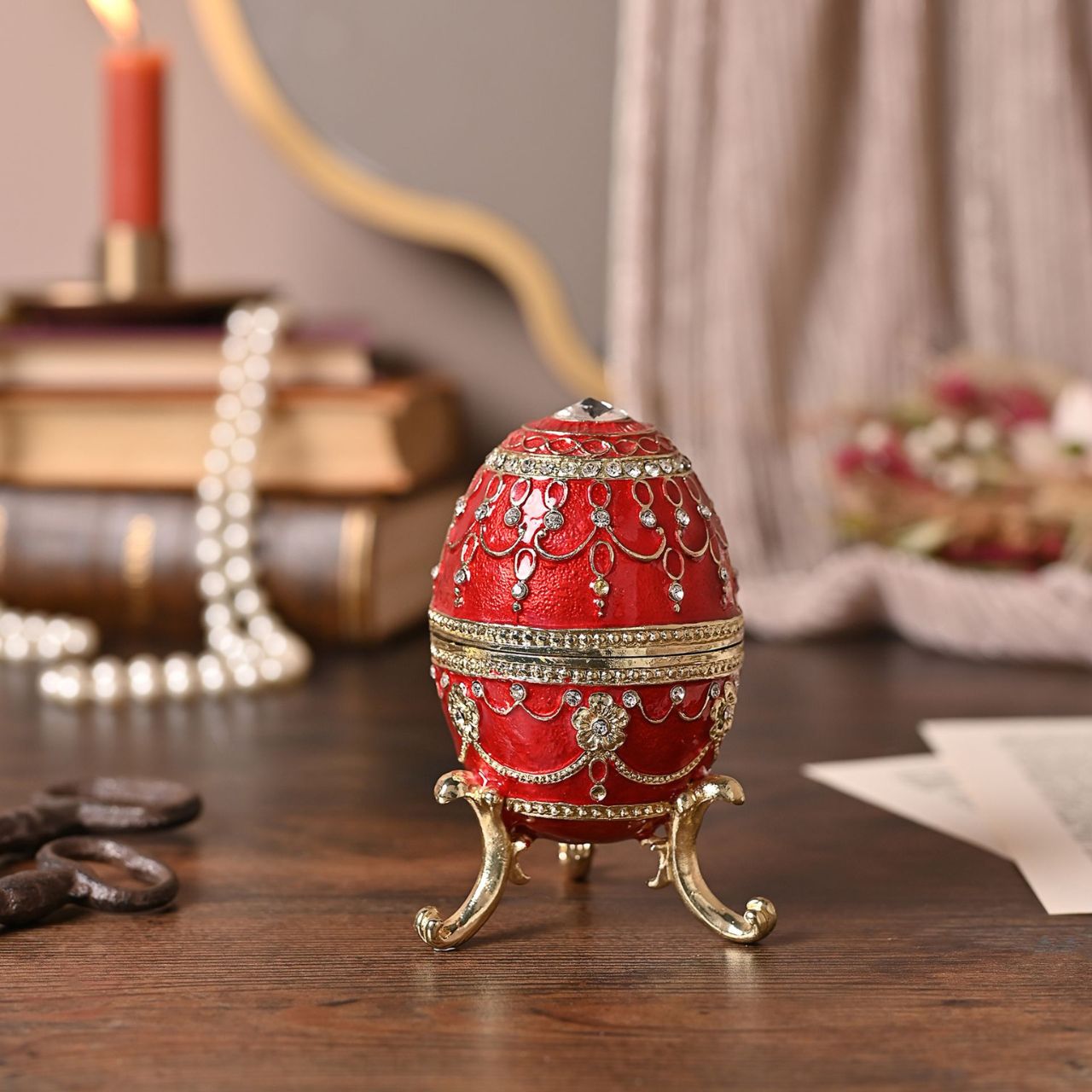 Painted in a majestic red colour with stunning gold and crystal patterns, this trinket box is a wonderful ornament to complement a mantelpiece, bookcase or cabinet.