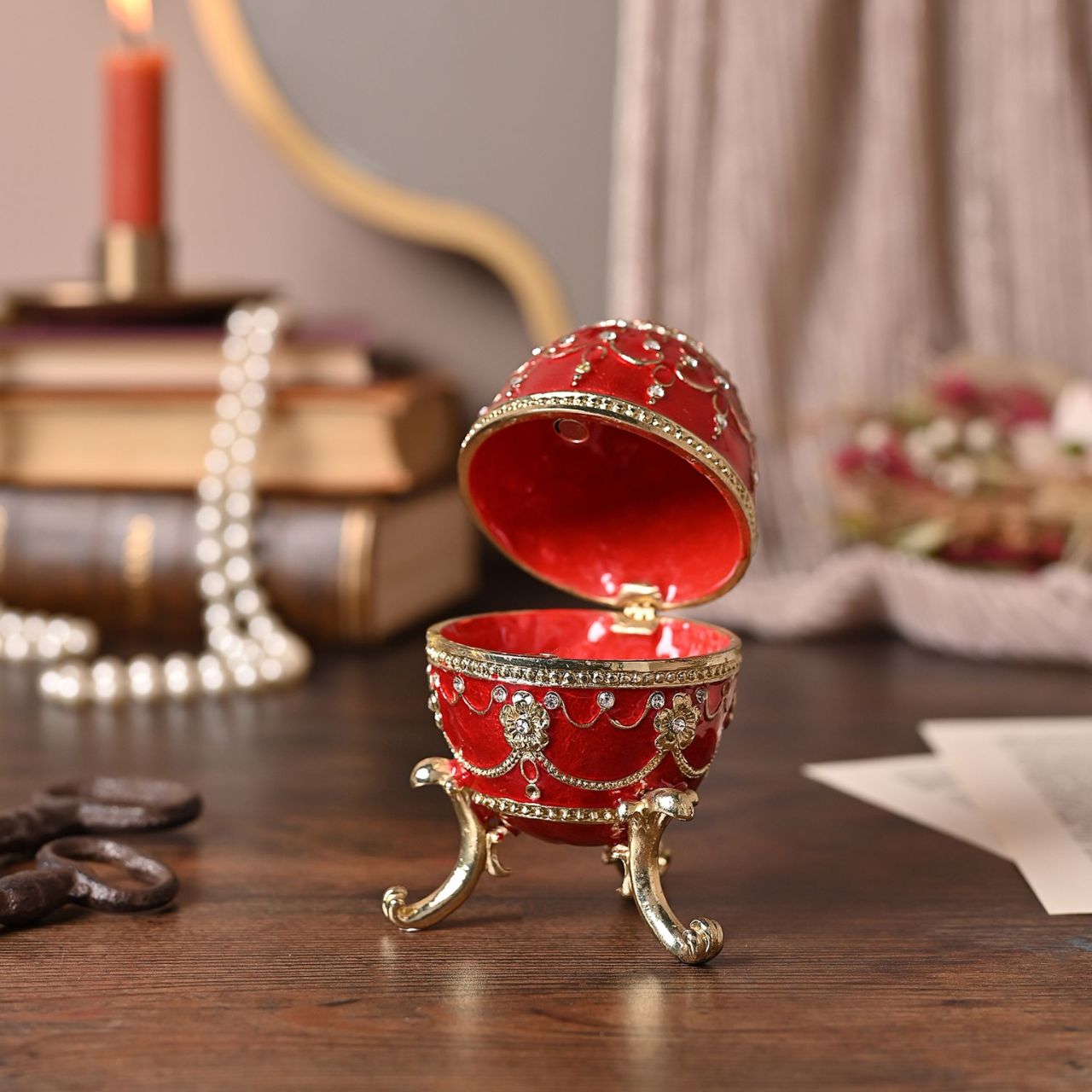 Painted in a majestic red colour with stunning gold and crystal patterns, this trinket box is a wonderful ornament to complement a mantelpiece, bookcase or cabinet.