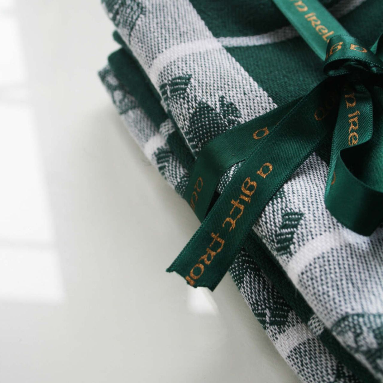 Treasures of Ireland Tea Towel Green by Samuel Lamont  Treasure of Ireland linen union tea towel in beautiful Irish green. This striking colourway comes as a bale of two, tied with elegant green ribbon. Perfect for gifting as a keepsake souvenir with it's iconic Irish symbols.