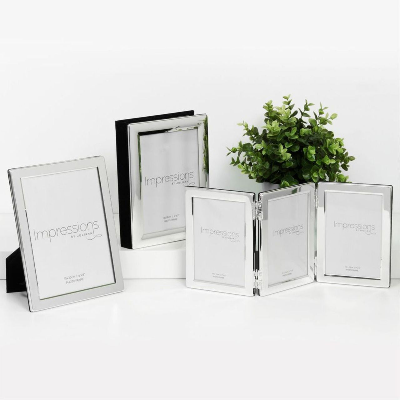 A hinged silver plated triple aperture photo frame from IMPRESSIONS by Juliana.
Each of the three apertures measures 5" x 7". Complete with standing strut and branded packaging.