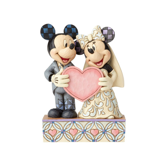 Disney Mickey Mouse and Minnie Mouse Figurine Two Souls, One Heart  This beautifully detailed figurine is a gorgeous depiction of Mickey as a doting groom with quilted accents on his suit and Minnie as a blushing bride in a gown with rosemaling details.