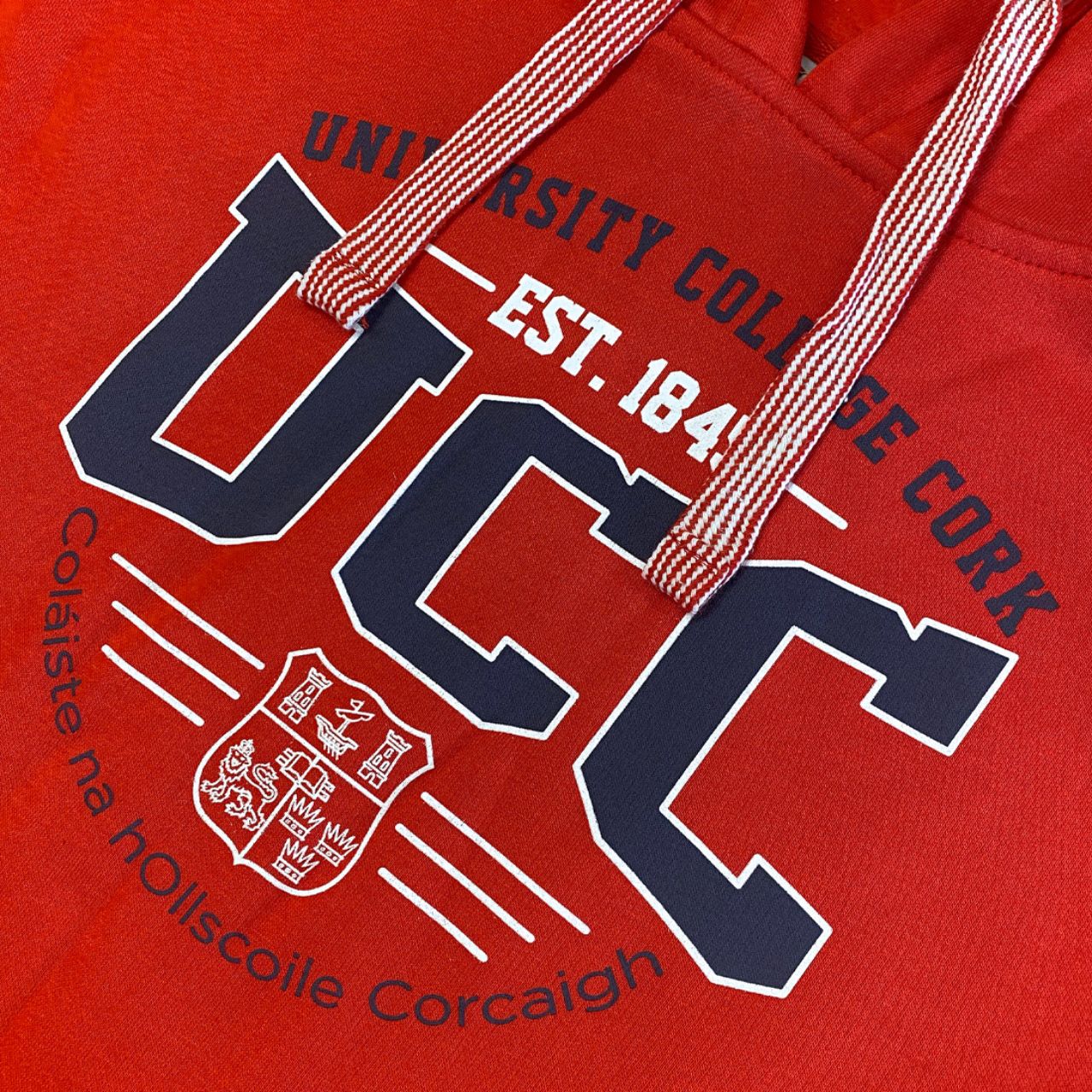 This UCC College Hoodie Est 1845 - Red is an official addition to the collection. Its relaxed fit showcases a printed UCC crest, UCC back neck label, contrasting draw strings, and a pocket with a UCC woven label.