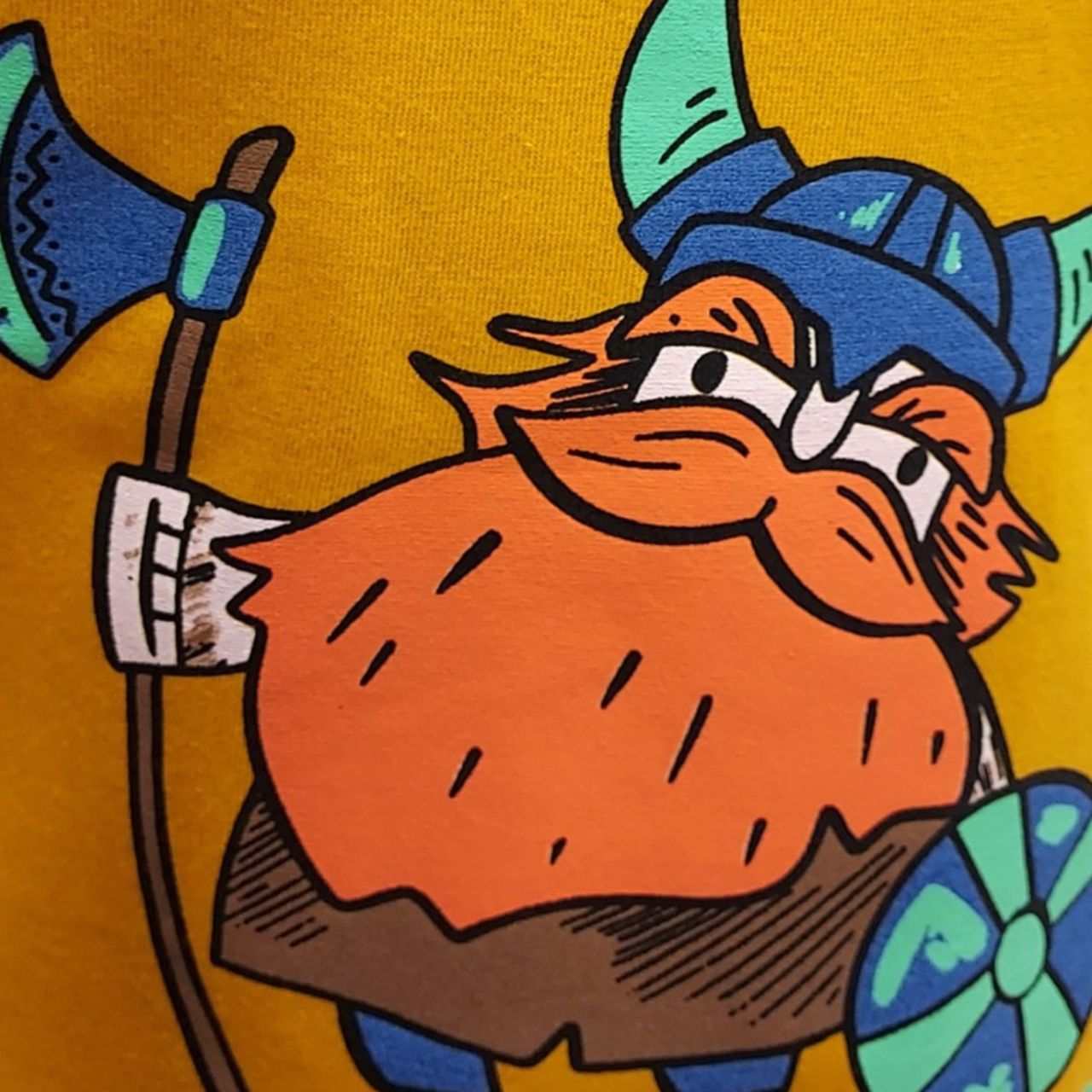 Showcasing a fun Viking design, the mustard kids' T-shirt adds a splash of color to any outfit. Crafted from soft, breathable fabric, it ensures comfort for active play and exploration.