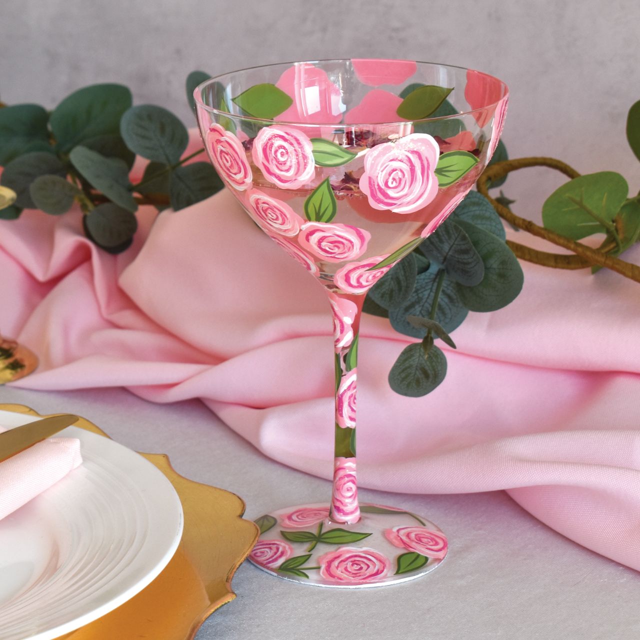 Celebrate Lolita's anniversary with our Vodka Rose Punch Cocktail Glass. A beautiful reminder of how Lolita first started Designs by Lolita. This particular beautiful floral design has pink roses surrounding the whole glass with green leaves. A beautiful design perfect for spring/summer. Try Lolita's Vodka Rose Punch cocktail on the base of the glass.