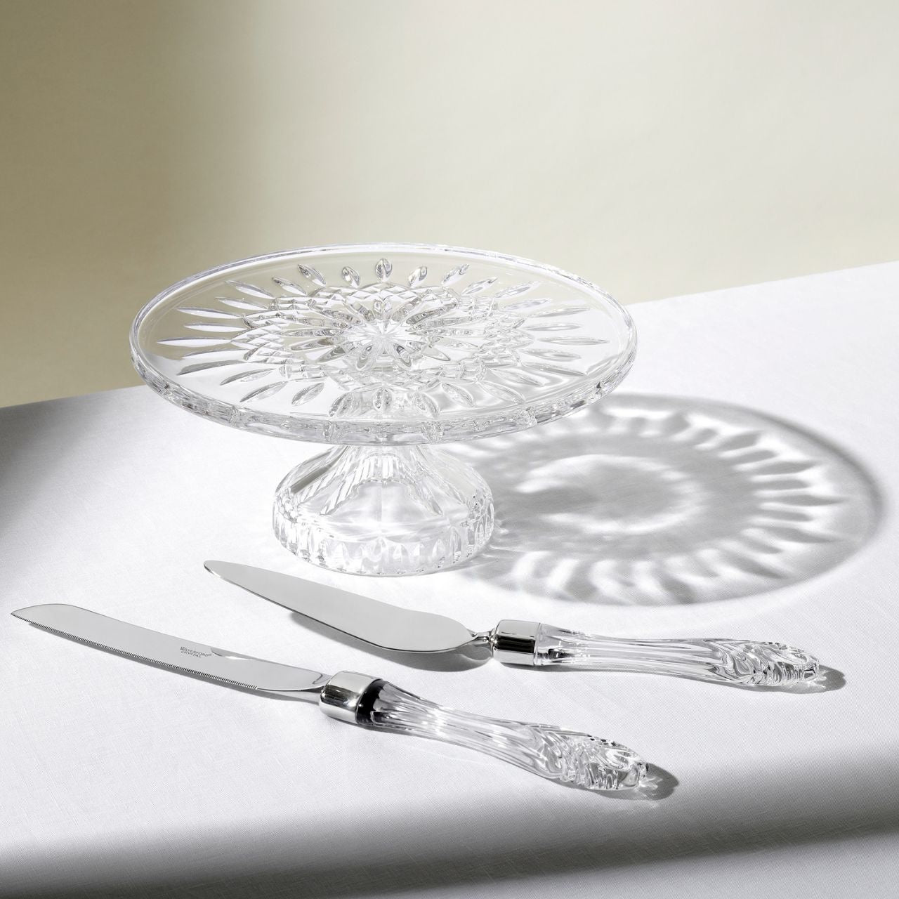 Lismore Cake Plate - Footed by Waterford Crystal  Featuring the iconic Lismore pattern, the Lismore Gift Bar Collection is inspired by the rich heritage of Ireland with pieces designed to be used and enjoyed. The Lismore Cake Plate 11 inch is perfect for serving up delicious cakes, sandwiches and biscuits. Lismore's signature diamond and wedge cuts create a brilliance and clarity that turns ordinary presentations into a special event.