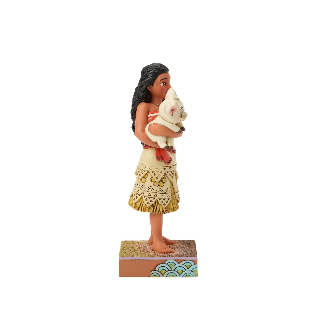 This intricate Jim Shore scene depicts Moana holding her best friend, Pua the pig, in a tight embrace. They smile together on a sand stage, with textured patterns and vibrant colour. Jim Shore's warm craftsmanship brings the scene to life.