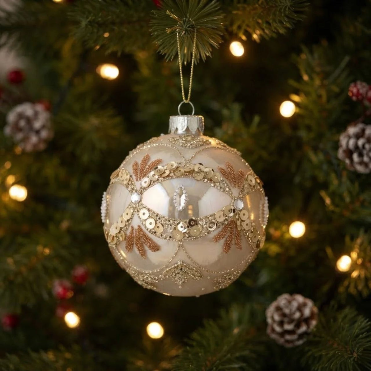 Elevate your holiday décor with the Gisela Graham White Pearl with Gold Scallops Christmas Bauble. This elegant glass ornament features a lustrous white pearl finish delicately accented by shimmering gold scalloped detailing. Perfect for adding a refined touch of sophistication and festive charm to your tree or seasonal arrangements.