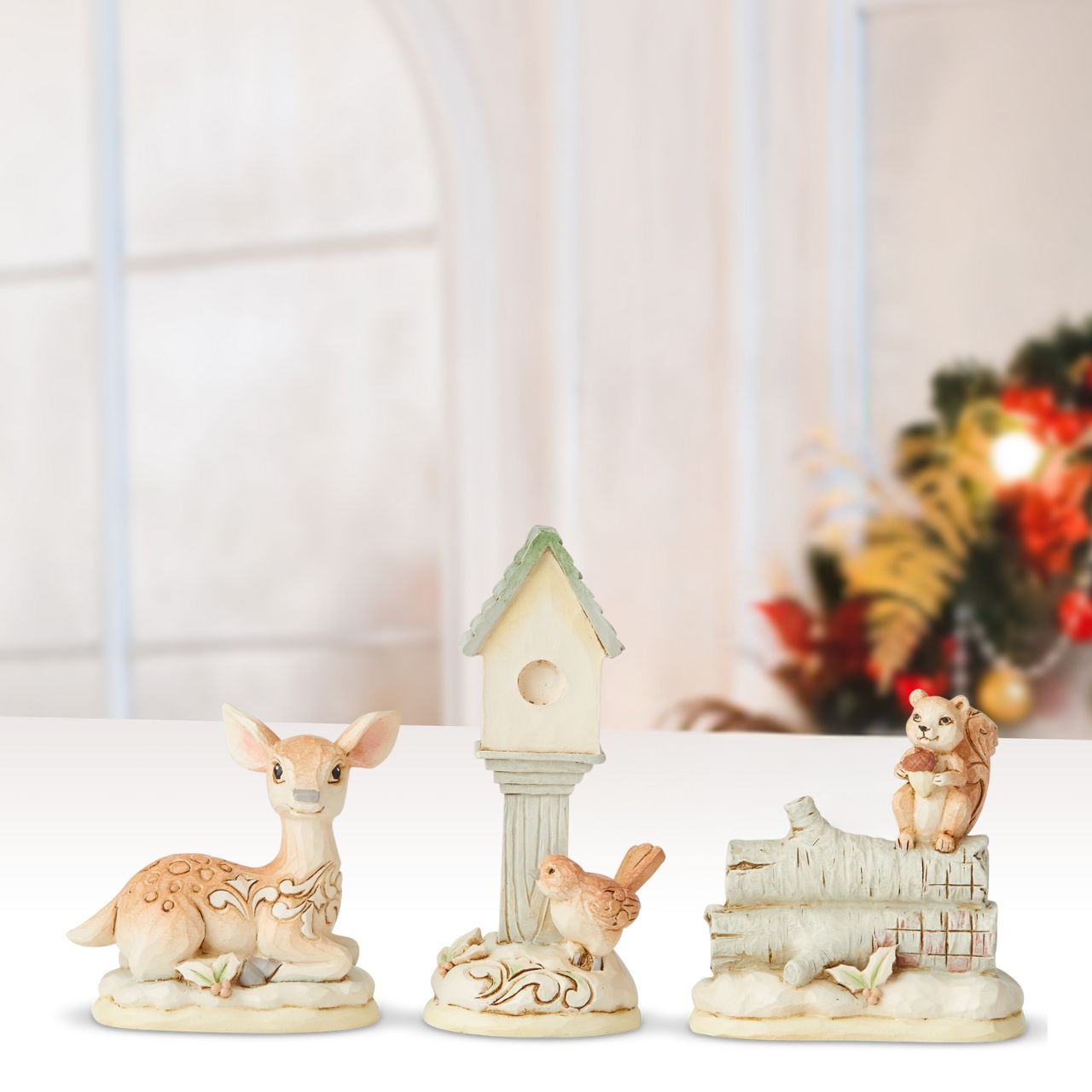 White Woodland Mini Accessory Set of 3  Beautifully decorated in delightful detail, this charming set of three White Woodland forest friends, a Bird with Bird House, a Deer and an adorable Squirrel, feature a wintry colour palette and Jim Shore's whimsical folk art design with holiday accents.