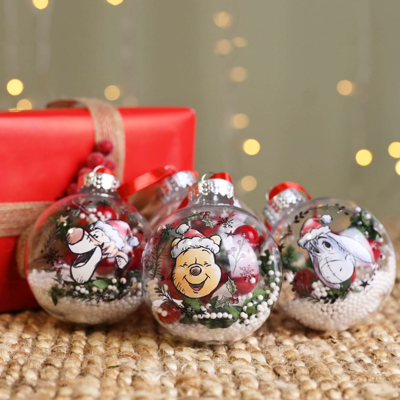Christmas Baubles Winnie the Pooh Set of 4  Make any tree a little more special this year by welcoming the warmth of Winnie the Pooh into the home. With heart-warming illustrations of the most recognisable characters, this set of baubles is sure to bring a smile to any little one's face.