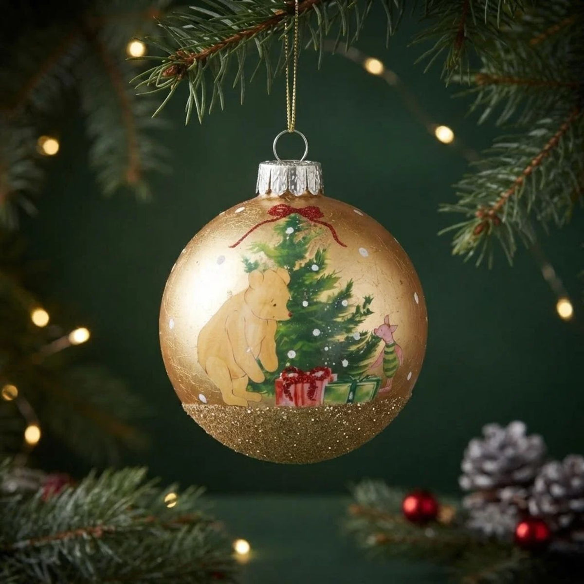 Bring beloved storybook charm to your tree with this enchanting Gisela Graham Winnie-The-Pooh Gold Leaf Christmas Glass Bauble. Crafted from quality glass, this collectible ornament features delicate gold leaf detailing that captures the warmth and whimsy of A.A. Milne's timeless character.