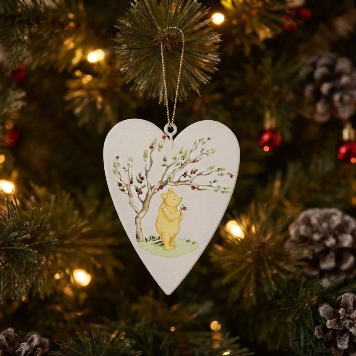 Celebrate baby's first Christmas with this charming Winnie-the-Pooh hanging ornament from Gisela Graham. Featuring the beloved character in festive design, it's the perfect keepsake for a nursery or tree.