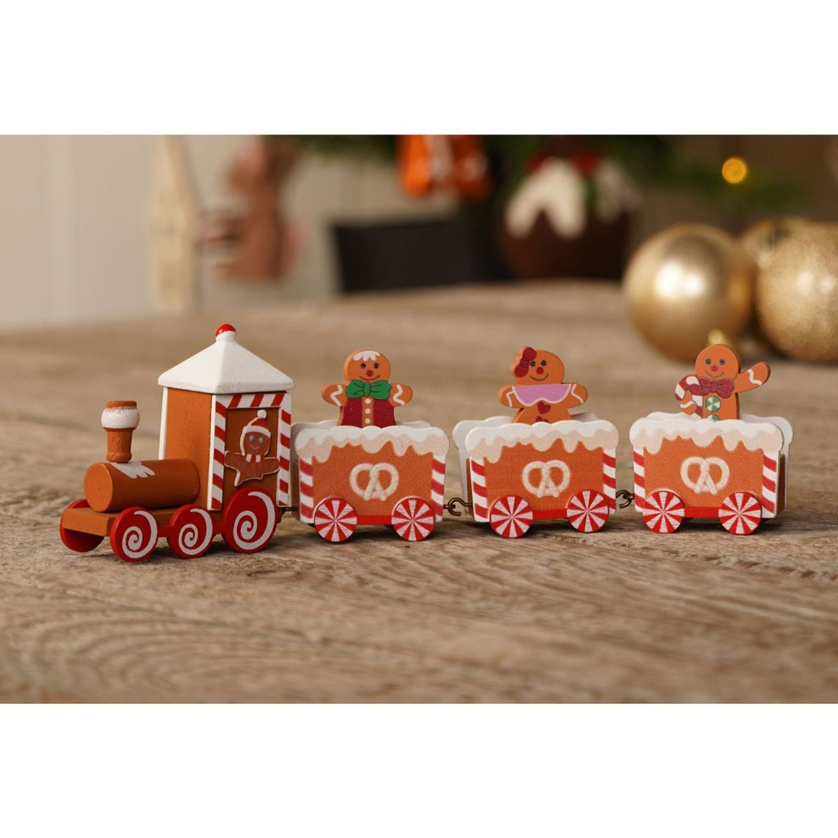 A wooden train made of gingerbread-style cookies - each piece features charming icing-look details and candy-cane accents, evoking home-made treats.