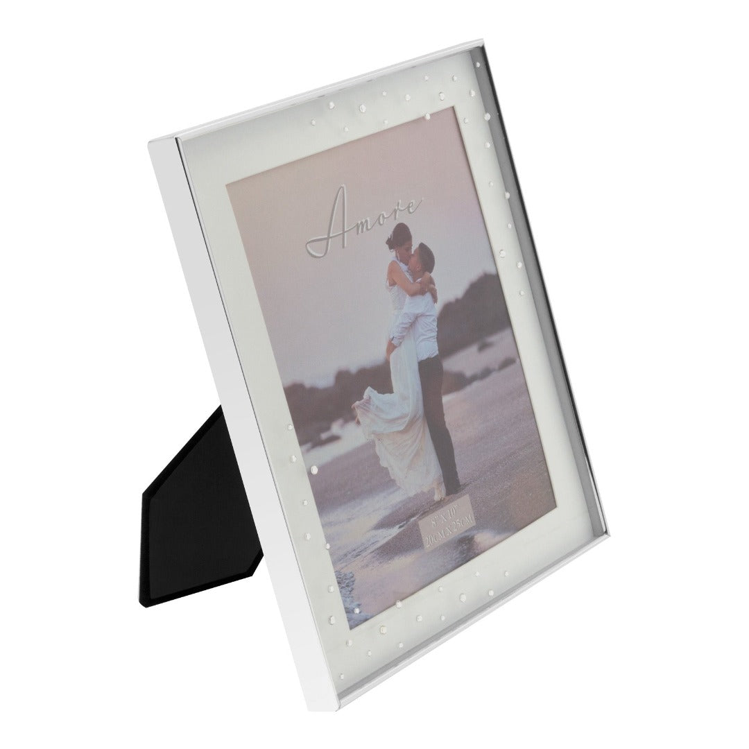 Amore Silver Plated Box Frame with Crystals 8" x 10"  A beautiful silver plated box frame with 8" x 10" (20 x 25 cm) aperture from the AMORE BY JULIANA® Wedding Day Collection. The frame features a crisp white mount and the glass is embellished with a spray of crystals. Complete with standing strut.