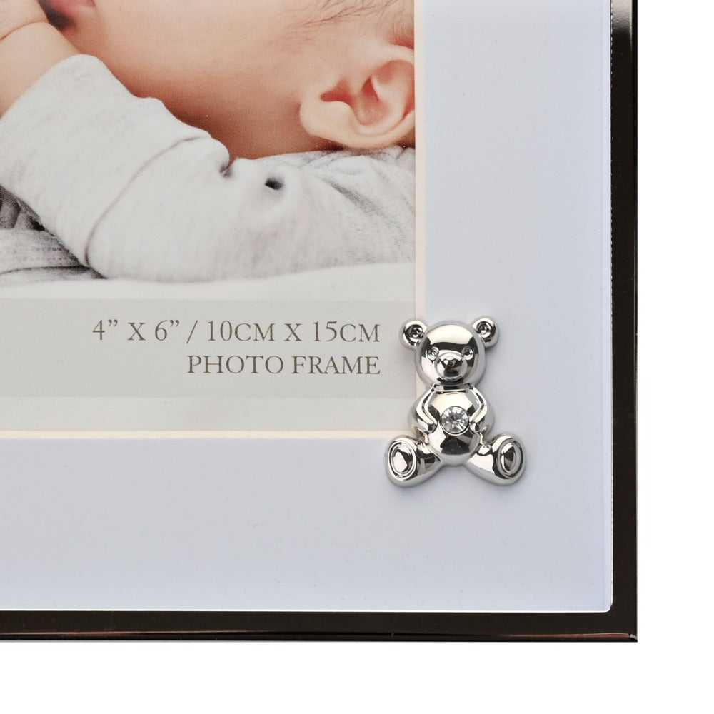 Bambino Silver Finish Frame - Teddy Blue Mount 4" x 6"  A gorgeous 4" x 6" (10 x 15 cm) nickel plated silver finish BAMBINO BY JULIANA® photo frame with a blue mount. The photo frame is embellished with a crystal finished silver teddy bear icon. Complete with a standing strut.