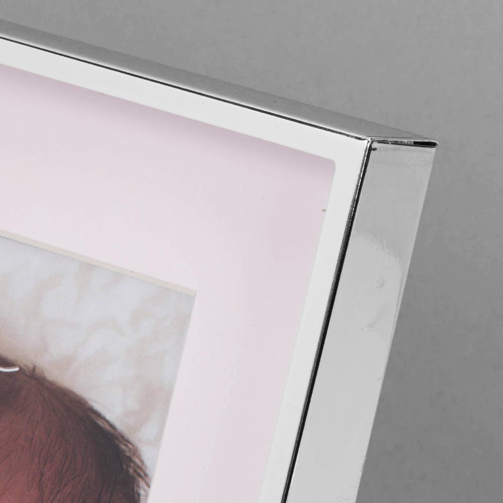 Bambino Silver Finish Frame - Teddy Pink Mount 4" x 6"  A gorgeous 4" x 6" (10 x 15 cm) nickel plated silver finish BAMBINO BY JULIANA® photo frame with a pink mount. The photo frame is embellished with a crystal finished silver teddy bear icon. Complete with a standing strut.