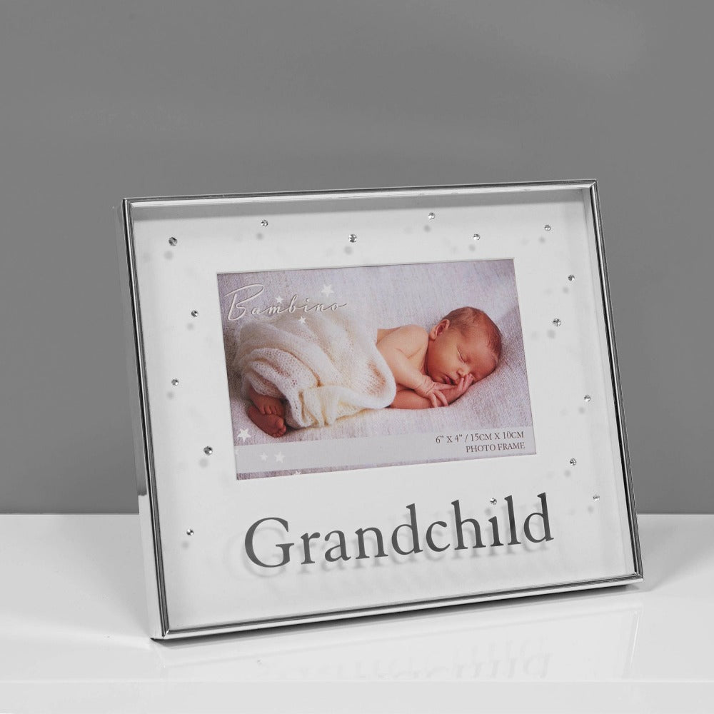 Bambino Silver Plated Photo Frame - 6" x 4" Grandchild  A beautiful silver plated 6" x 4" (15x10cm) 'Grandchild' photo frame from BAMBINO BY JULIANA®. The frame features a crisp white mount, mirror 'Grandchild' title on the glass and crystal embellishments. Complete with luxury black velveteen standing strut.