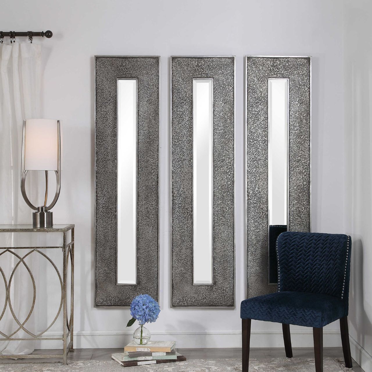 Bannon Mirror by Mindy Brownes - NEW  This rectangular mirror features a heavily textured surface finished in a metallic silver leaf with a heavy charcoal wash over a solid wood construction. This contemporary design boasts a great profile for showing individually or multiple for a bold statement. The mirror is bevelled and can hang vertically and horizontally.