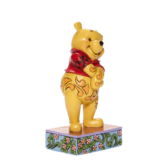 Jim Shore Beloved Bear Winnie the Pooh Personality Pose Figurine  Celebrating the 95th anniversary of the Winnie the Pooh book, this Silly Ol' Bear is happily smiling with his belly full of honey. Jim Shore's design captures the personality of the beloved Winnie the Pooh from the Hundred Acre Wood.