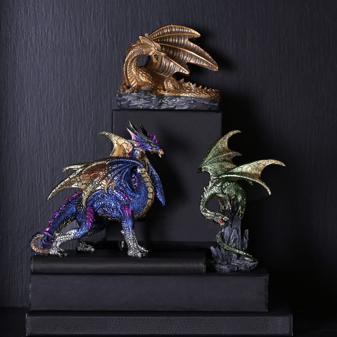Blue Dragon With Gold Wings Figurine  A blue dragon with gold wings figurine by HOCUS POCUS NOVELTIES®.  This majestic figurine captures the mythical world of dragons for those obsessed with fantasy.