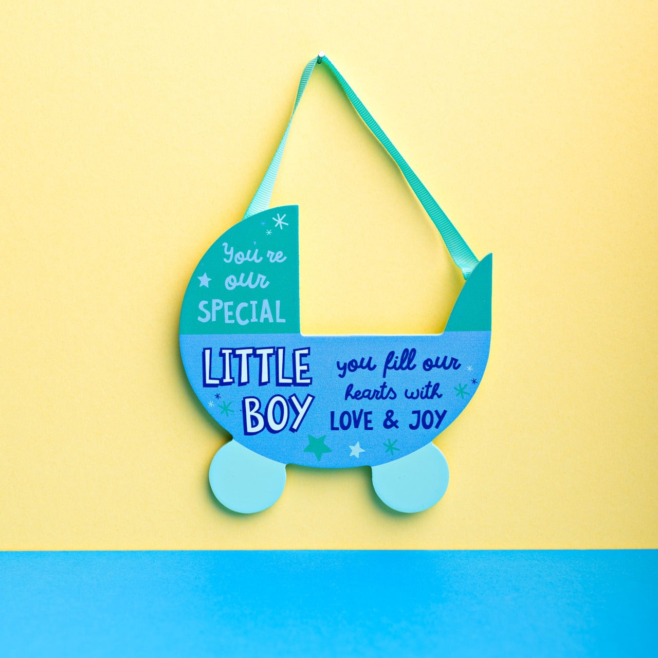 Blue Pram Hanging Plaque - Little Boy  Want to show someone you care? Then why not gift this ‘Little Boy’ bright, uplifting and cheerful pram plaque as a token of your love.