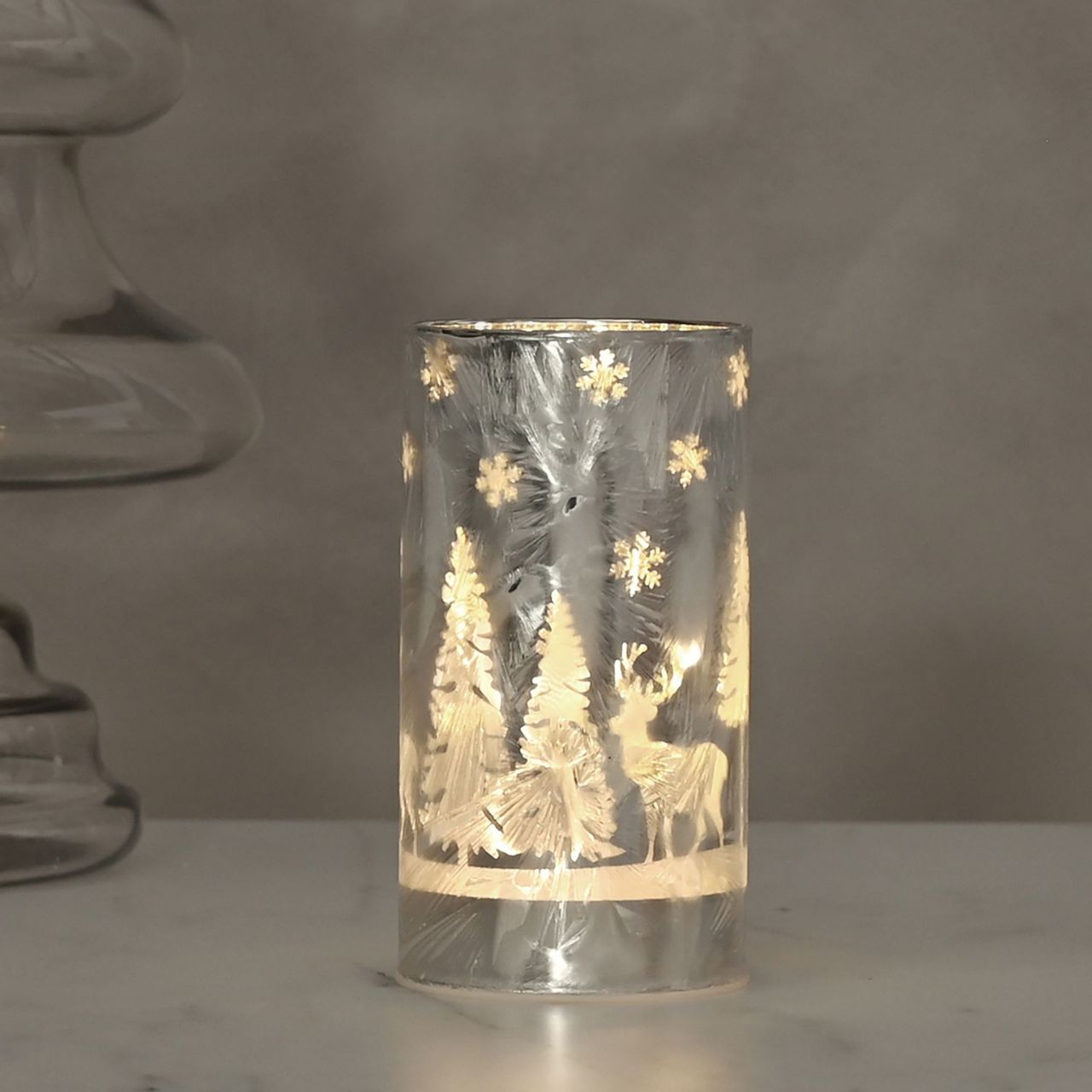 Frosted Reindeer Christmas Forest Scene Small LED Tube Light  A Frosted Reindeer LED tube light.  This illuminating decoration is a delightful twist on the traditional this Christmas.