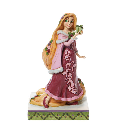 Jim Shore Gifts of Peace - Rapunzel with Gifts Figurine  Hair full of flowers, Rapunzel will be swinging to your home this season. Boasting a broach of holly and carrying a tightly wrapped gift, this princess will be delivering presents all across the kingdom in this Jim Shore design. Hand painted and hand crafted from high quality cast stone.