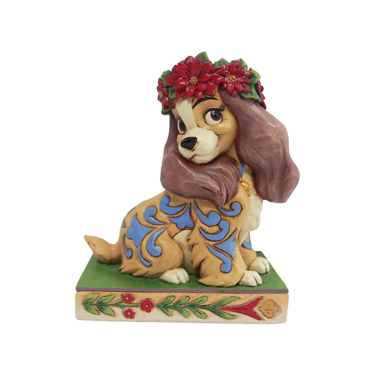 Jim Shore Christmas Lady Personality Pose Figurine  Lady, the regal Cocker Spaniel, wears a crown of holly in this lovely relief by Jim Shore. Her classic blue collar is matched by gorgeous rosemaling running down her coat.