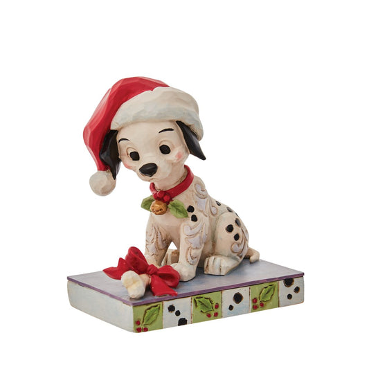 Jim Shore Christmas Lucky Personality Pose Figurine  With one hundred and one brothers and sisters, Christmastime is a delight for Lucky. Enjoying the winter in London, Lucky savours a bone while he wears holly and a Santa hat decked out in Jim Shore's intricate detail.