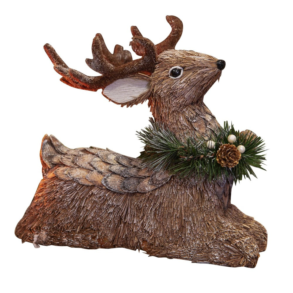 Christmas Sitting Reindeer Ornament  Create a rustic and comforting Christmas woodland decor theme with this handmade straw reindeer figurine. From the Enchanted Forest collection by Santa's Workshop - create your own winter wonderland.