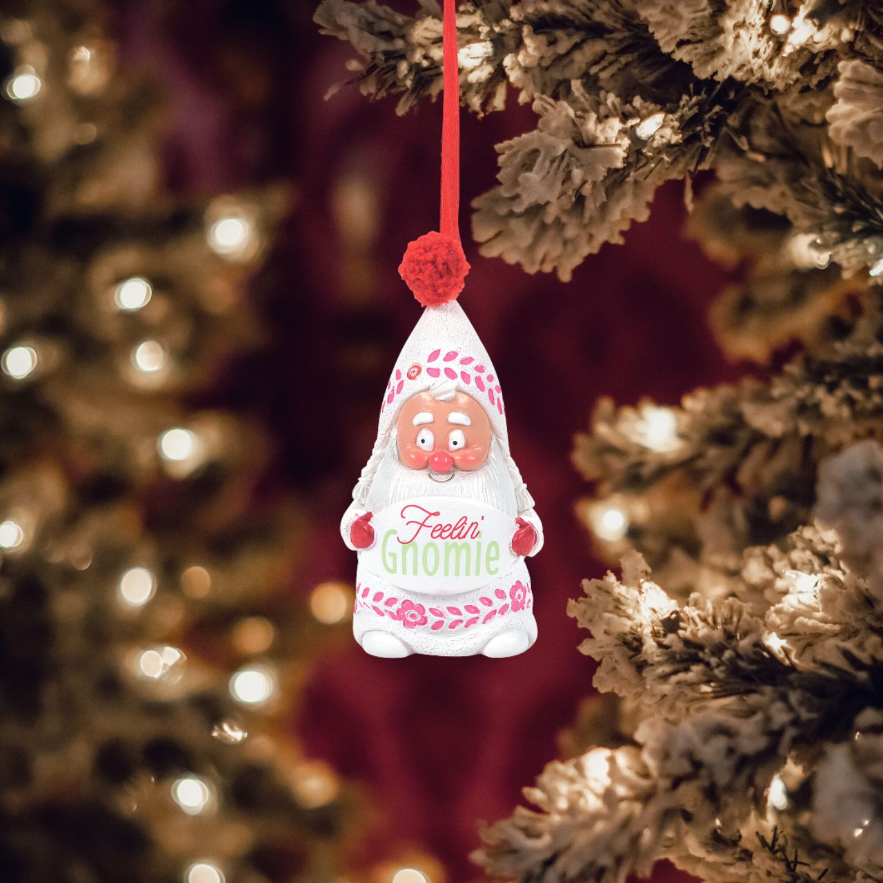 Department 56 Snowpinions Snow Gnome Feelin' Gnomie Hanging Ornament  This happy little Snow Gnome is the perfect Christmas tree accessory. Crafted from high quality cast stone before being hand painted and topped with a real pom pom. The perfect gift for loved ones or yourself this festive season.