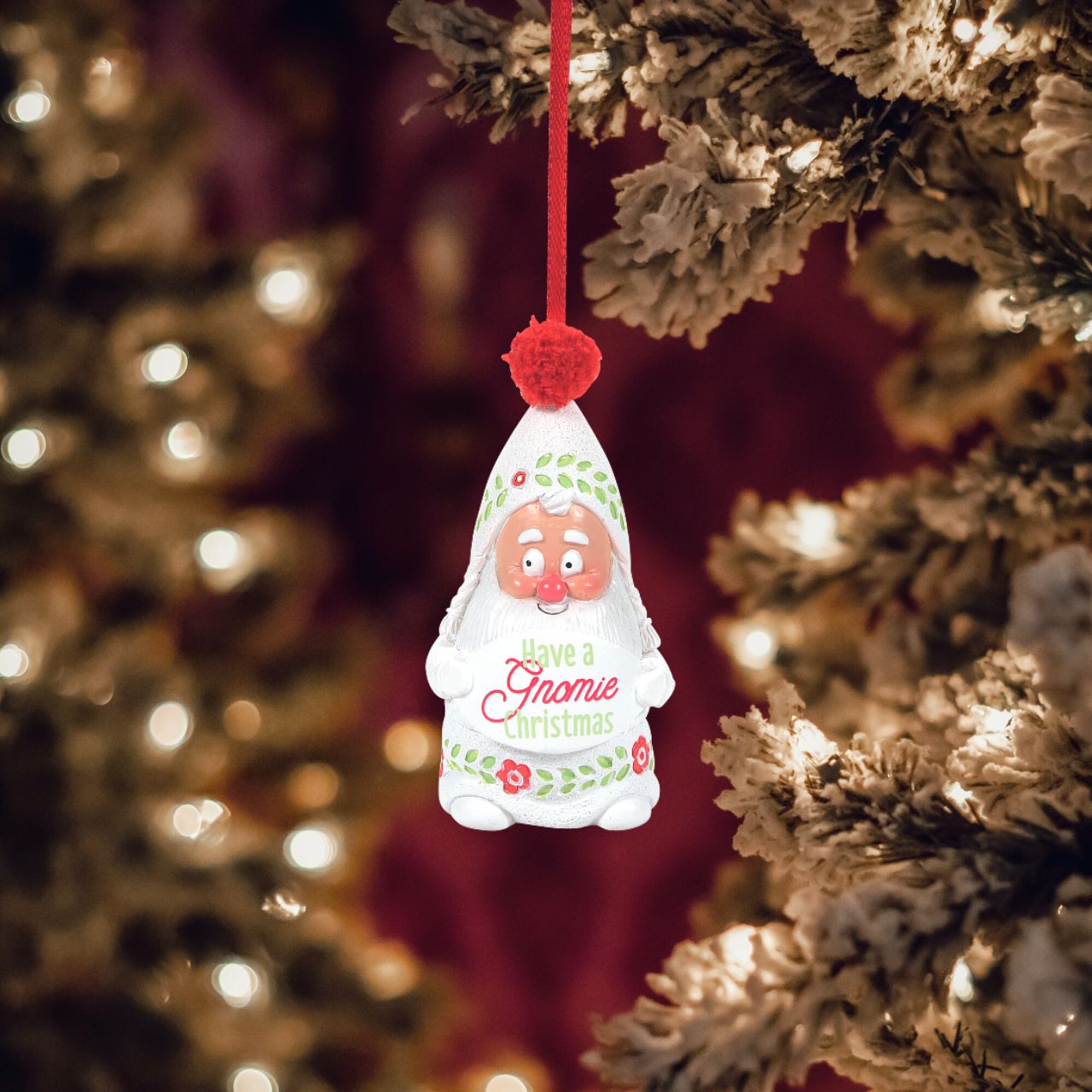 Department 56 Snowpinions Snow Gnome Have a Gnomie Christmas Hanging Ornament  Upon a festive red ribbon, this Snow Gnome is perfect for any Christmas tree. Hand crafted from high quality cast stone, hand painted by our talented artists and topped with a real pom pom. Spread the holiday cheer - Have a Gnomie Christmas.