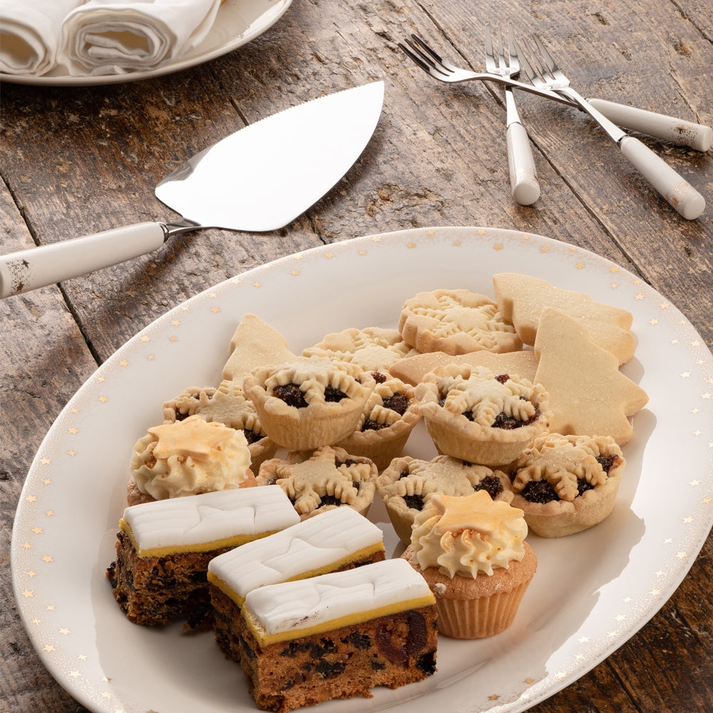 Christmas Stardust Pastry Server, Knife & Fork by Belleek Living  Stardust features contemporary coupe shapes and a delicately stippled gold band with scattered gold accent stars adorning the edge. This set is subtle and elegant with a whimsical twist; the ideal pattern to add a bit of understated sparkle to any table for a special occasion.