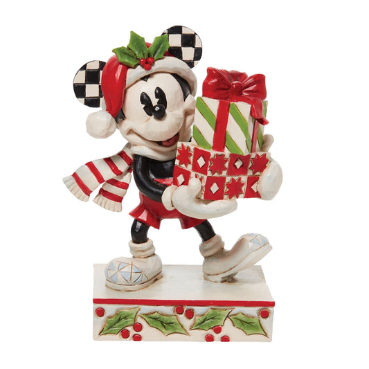 Jim Shore Christmas Mickey with Stack of Presents Figurine  Disney comes home for the holidays with this festive figurine by Jim Shore. Donning a candy cane striped scarf, Mickey wears a neighborly smile as he carries a towering stack of presents. The cheerful mouse boasts a holly brimmed Santa hat.