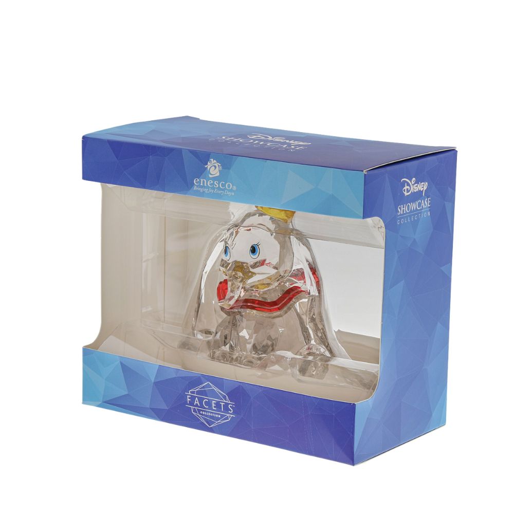 Dumbo Facets Figurine  This "gem cut" acrylic sculpture reflects the ninth wonder of the universe. The world's only flying elephant. Dumbo is already for his circus debut with his yellow hat and pink collar. Presented in a branded window gift box.