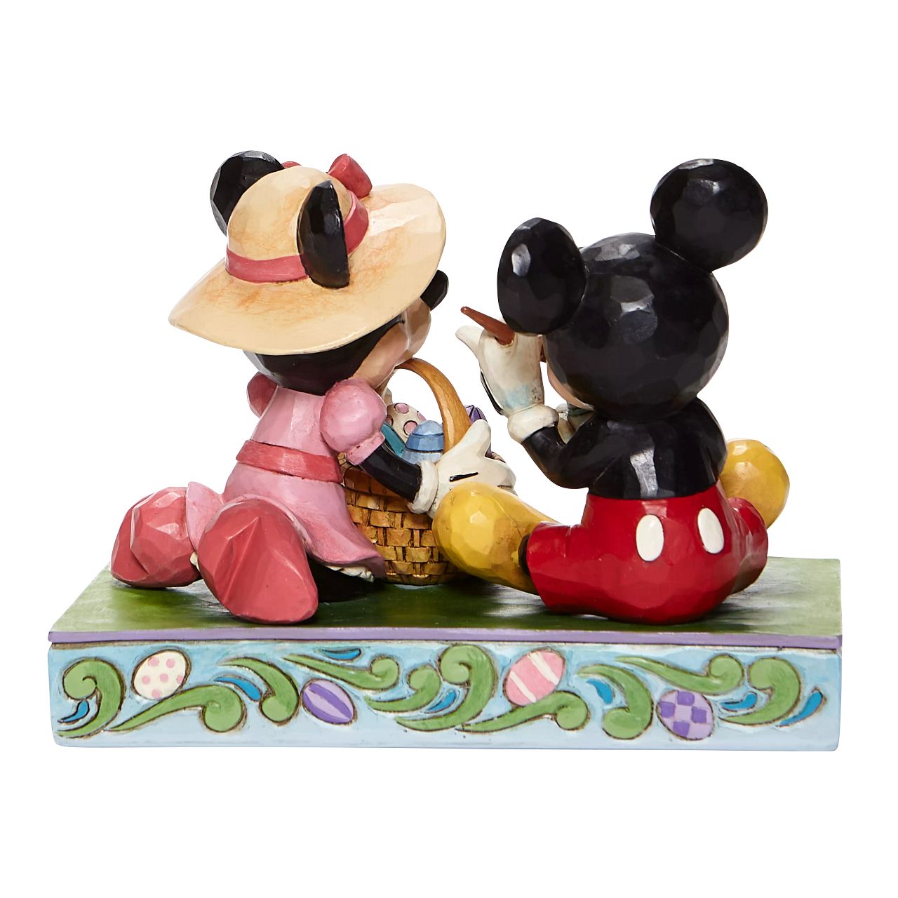 Jim Shore Easter Artistry - Mickey and Minnie Easter Figurine  In this joyful scene, Mickey and his sweetheart Minnie, are filled with excitement as they perfect their eggs for an egg hunt. Brighten up your collection with this vibrantly, colorful Easter piece by Jim Shore.