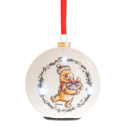 Christmas Disney LED Flashing Winnie Bauble  Make any tree a little more special this year by welcoming the warmth of Winnie the Pooh into the home. With a cheerful illustration and an LED flashing light, this bauble is sure to bring a smile to any little one's face.